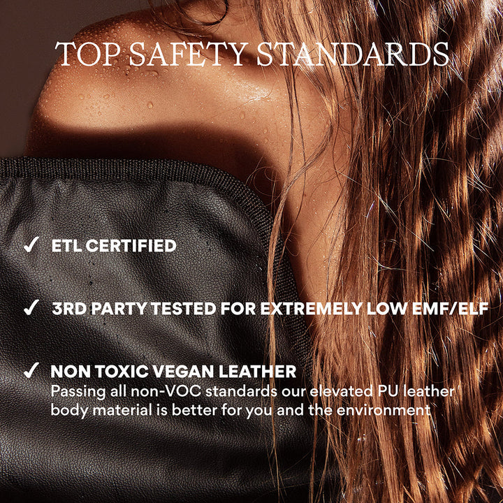 A close up view of a woman's sweating half shoulder, a the mat just below the shoulder blade and hair covering the other half. A text overlay says Top safety standards, etl certified, third party tested for extremely low emf/elf, non toxic vegan leather, passing all non-VOC standards our elevated PU leather body material is better for you and the environment