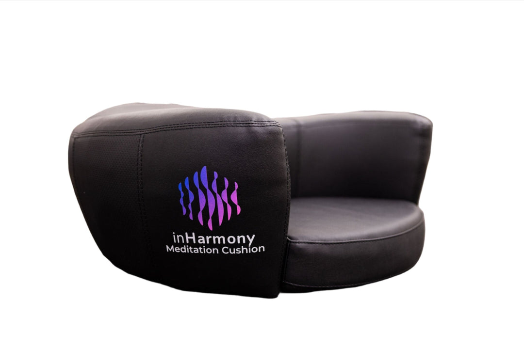 A black cushion with a close up on its logo, squiggly lines with a text below, inHarmony Meditation cushion