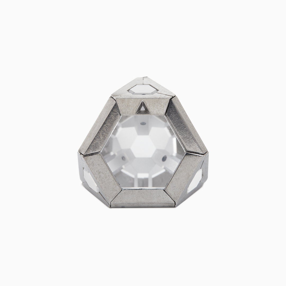 A crystal inside an encased silver metal shaped in dodecahedron- a 12 sided polyhedron