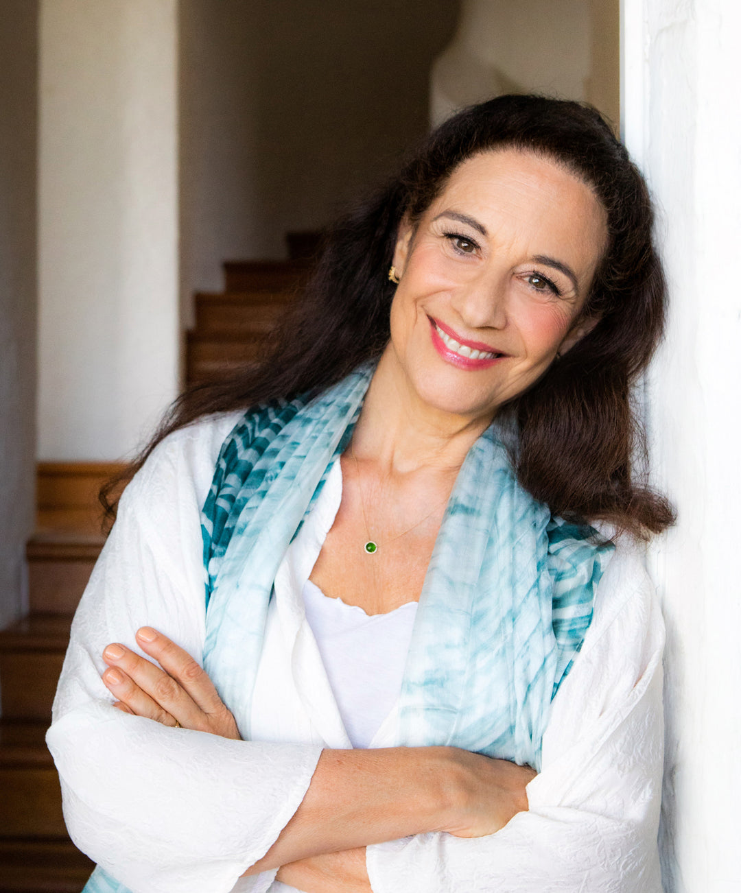 Image of woman smiling leaning against wall