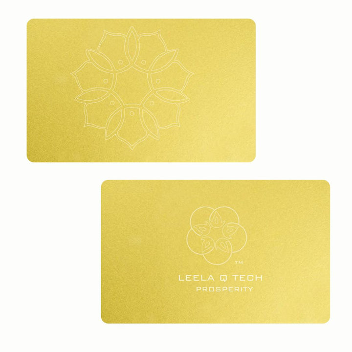 Two gold cards where one has a lotus graphic logo in the center while the other one has a five petaled-flower logo with a TM beside it. Below is a text logo, Leela Q Tech, prosperity