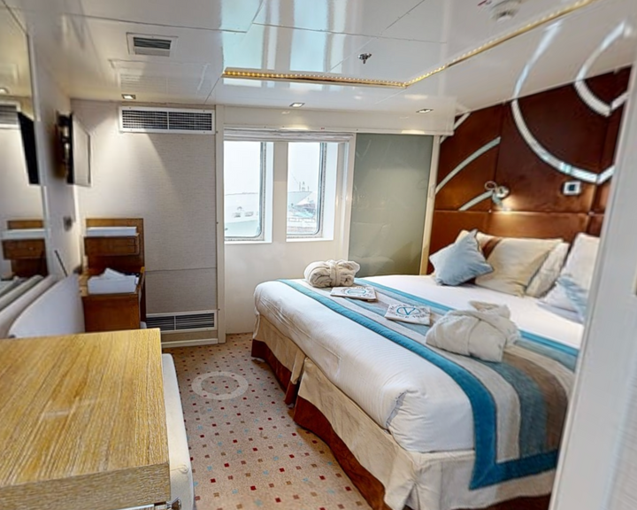 Riviera Cabin with convertible beds and ocean-view windows aboard the M/Y Variety Voyager