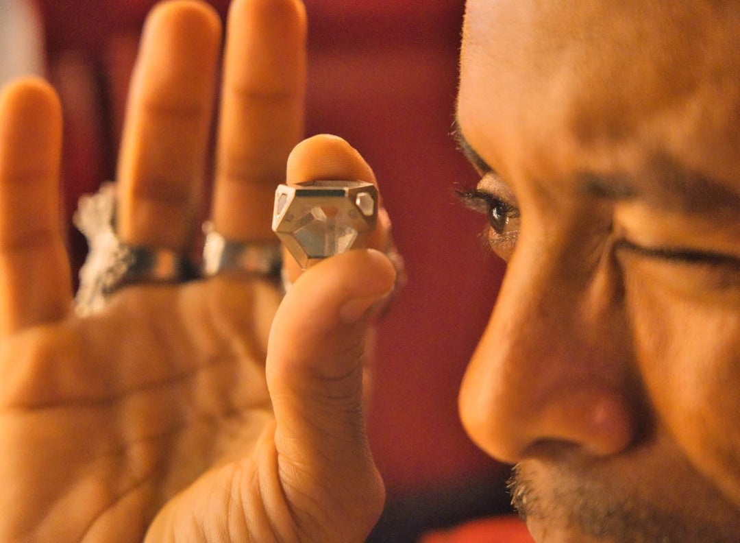 Man looking through a clear quartz ARK crystal