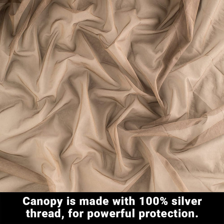 A close up of a creased and random folds of fabric with a text below, canopy is made of 100 percent silver thread, for powerful protection