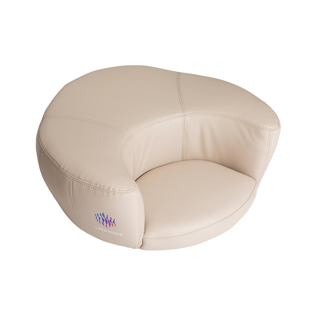 A side view of a white cushion showing its logo, a squiggly lines and a text below it, inHarmony