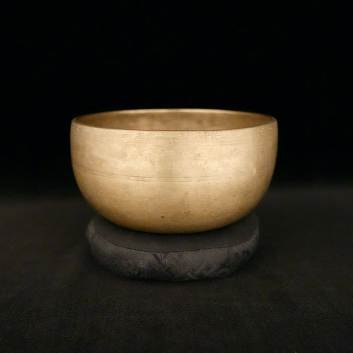 A gold bowl sits on a small pillow