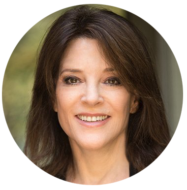 A headshot of a smiling  brunette woman