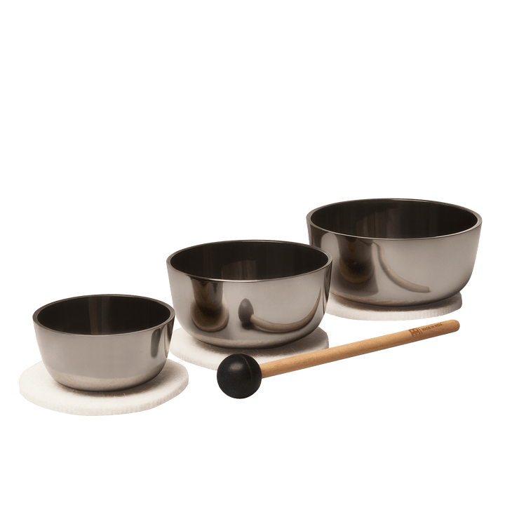 3 bowls of different sizes are arranged diagonally aligned, placed over a felt mat and a ball headed mallet placed in the front