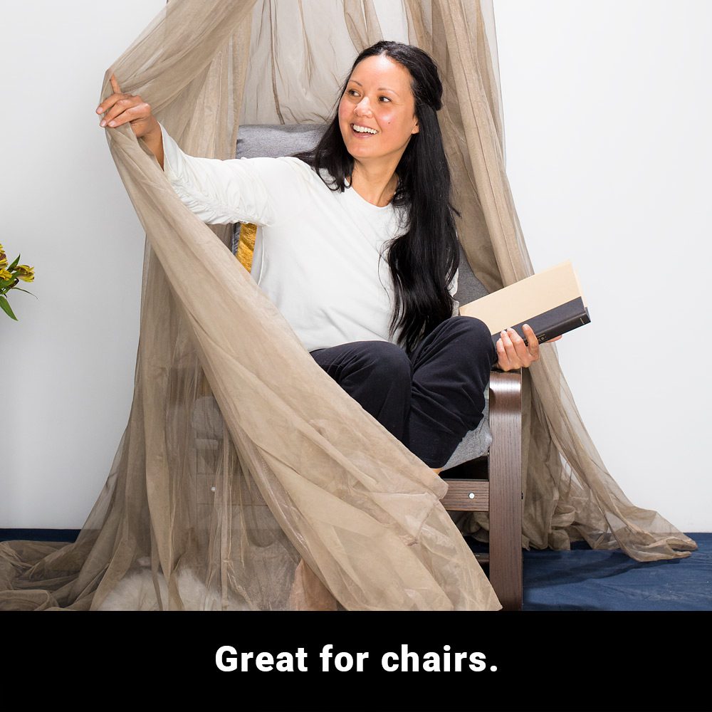 A woman sitting on a chair, smiling while holding the draped fabric from above on her right hand and a book on her left. A text below says, great for chairs.