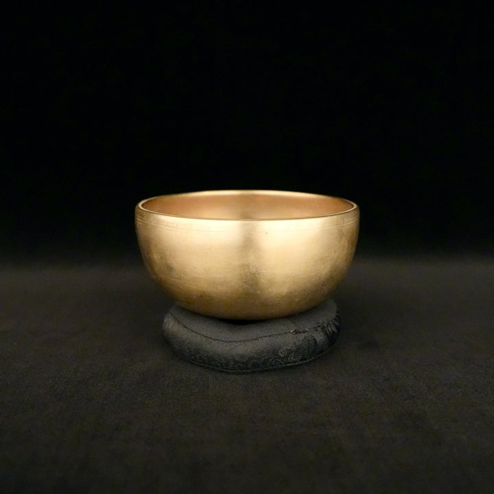 A gold bowl sitting atop a pillow